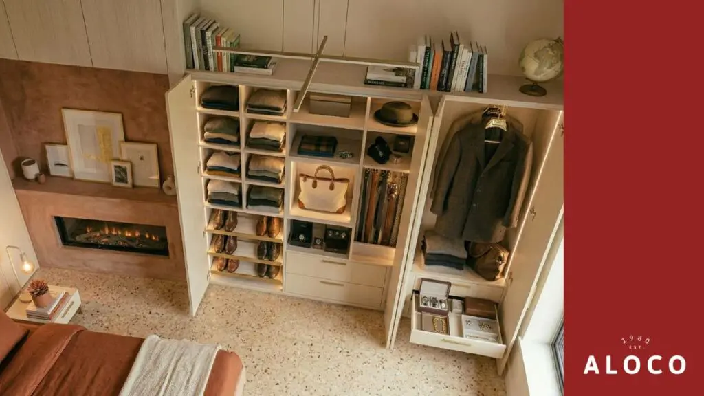 overhead show of a beige custom wooden wardrobe full of clothes with inner light fixtures | aloco