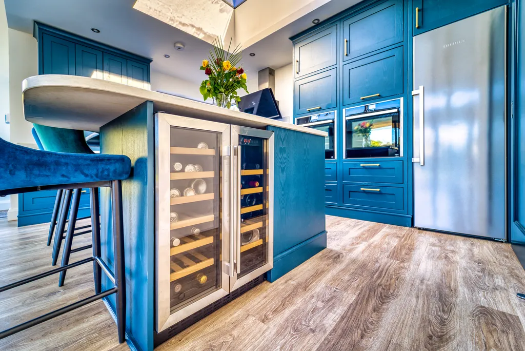 Close up of glazed wine coolers built into a blue kitchen island