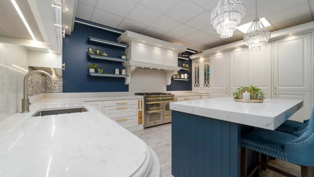 Blue and white kitchen showing curved marble worktop and island