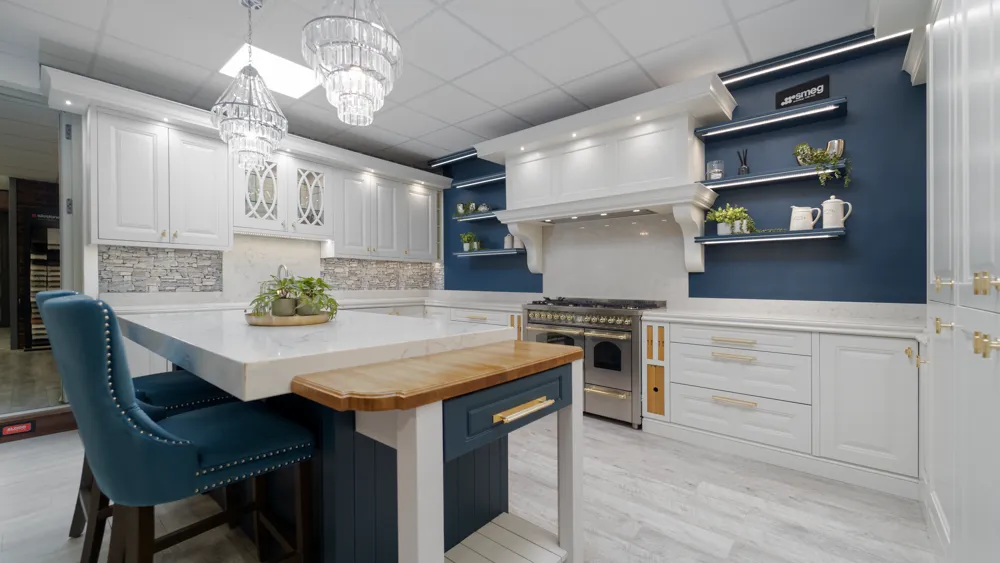 Blue and white kitchen with marble island and crystal chandeliers