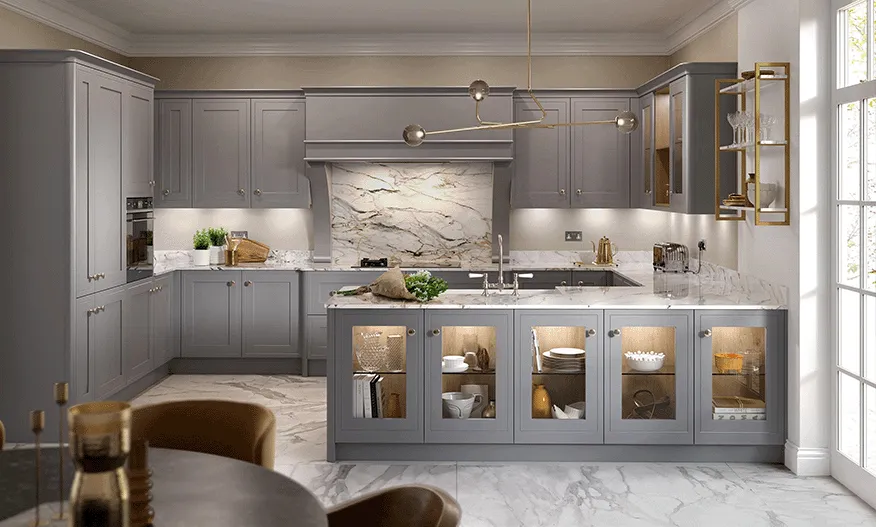 Dove grey kitchen with illuminated glass display cabinets and marble splashback