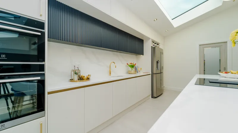 Built-in Electrolux double ovens in white handleless kitchen tall units