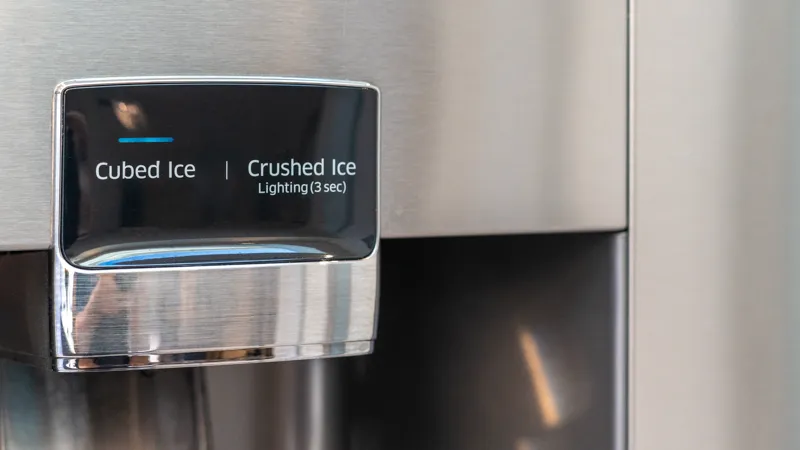 Ice and water dispenser detail on a stainless steel American fridge