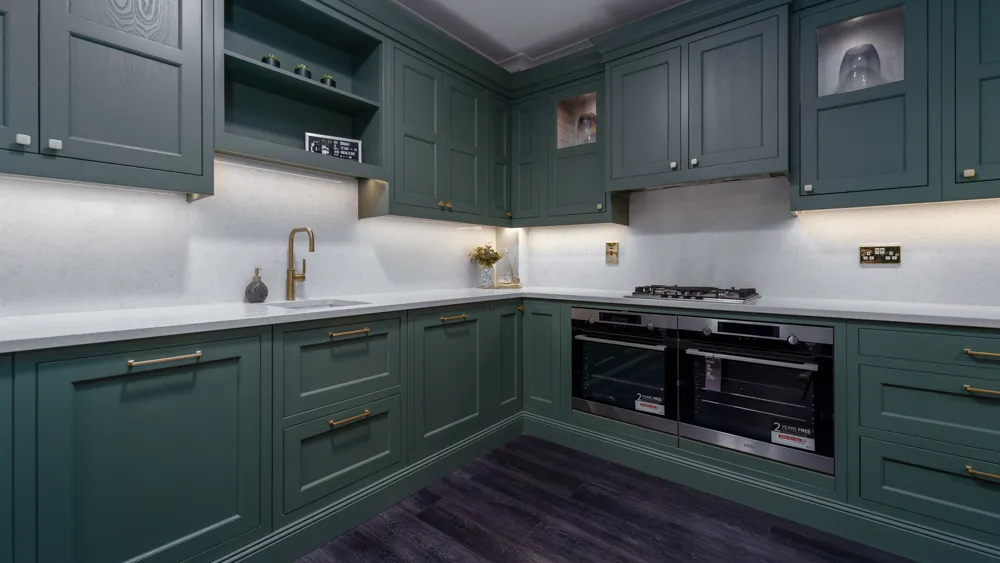 Wide view of green shaker kitchen with double ovens and hob