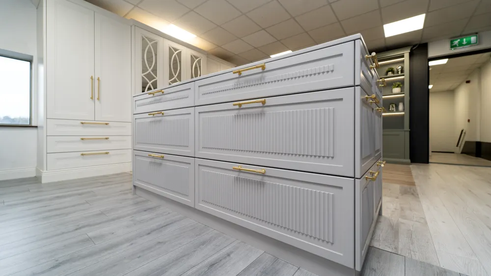 Grey fluted dressing room island unit with brass handles
