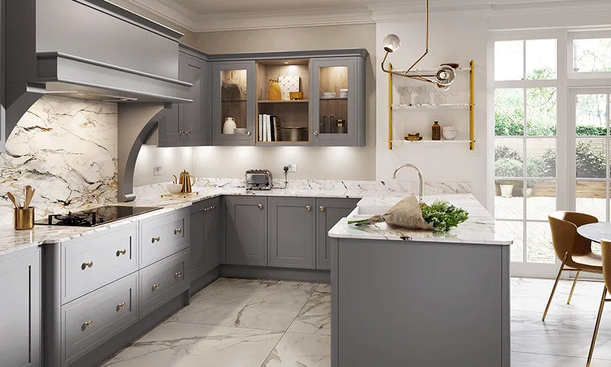 Grey shaker kitchen with veined marble splashback behind the gas hob