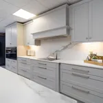Light grey shaker kitchen with extractor canopy and quartz worktops