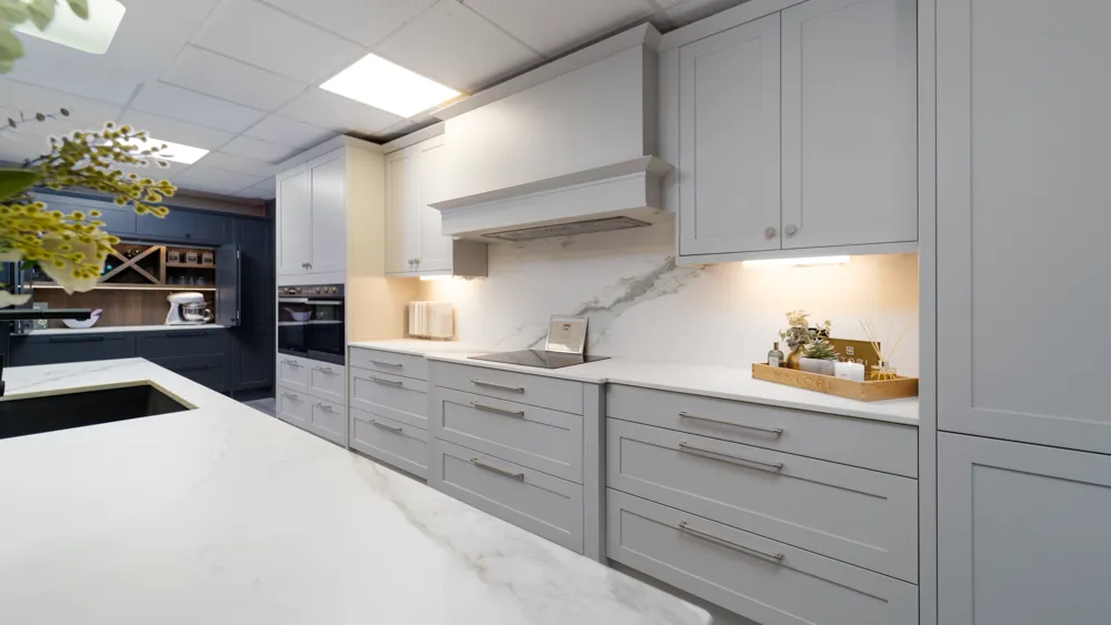 Light grey shaker kitchen with extractor canopy and quartz worktops