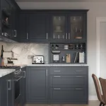 Midnight blue shaker kitchen with marble worktop and glazed wall cabinets