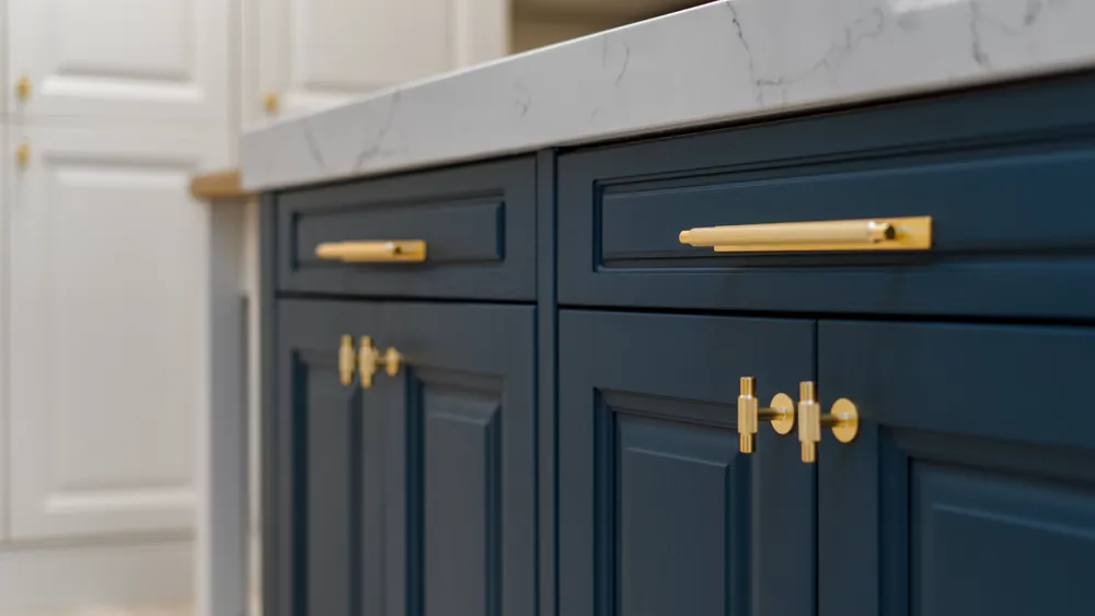 Angled detail of brass knurled handles on navy blue doors