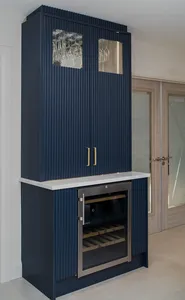 Navy fluted drinks cabinet with brass handles and integrated wine fridge
