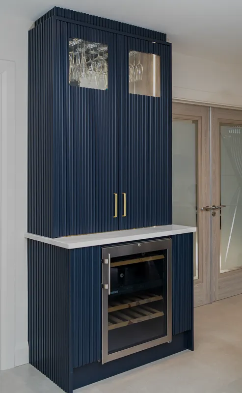 Navy fluted drinks cabinet with brass handles and integrated wine fridge