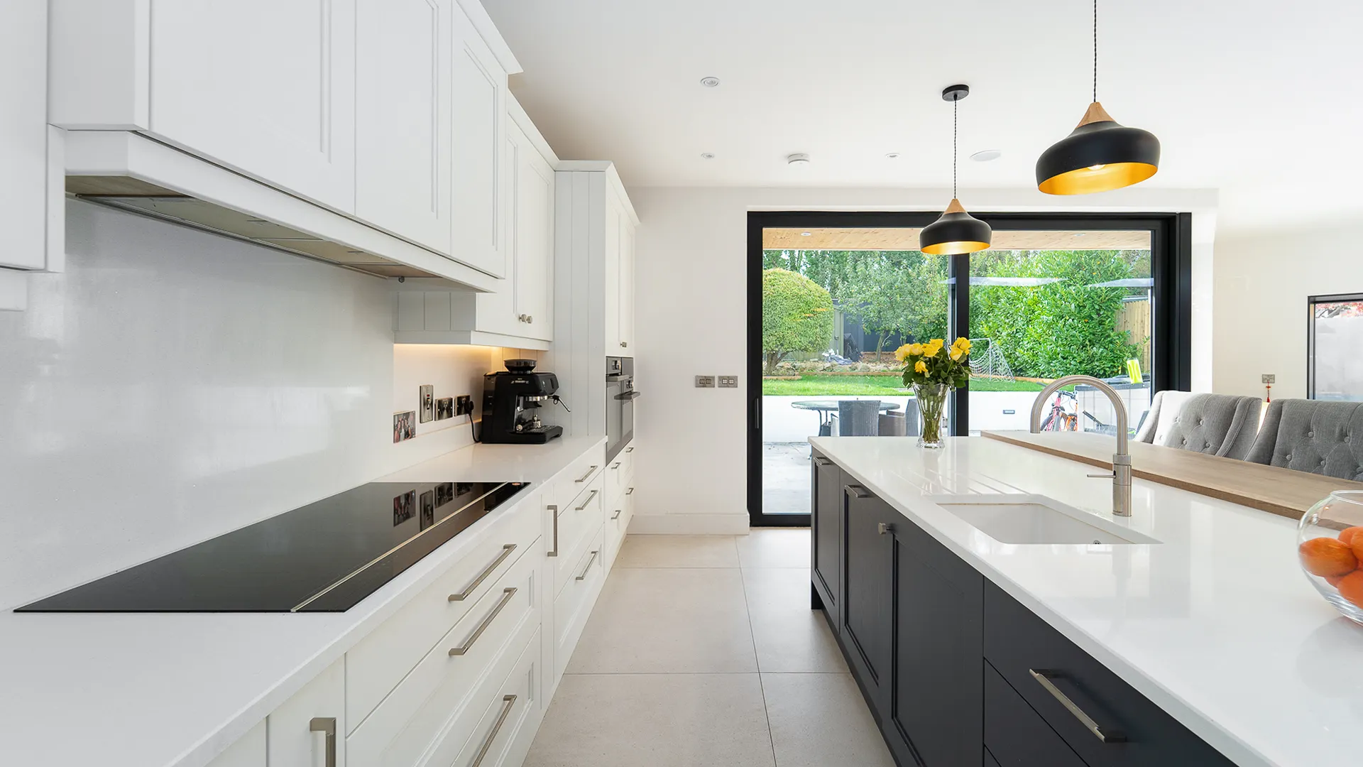 Navy island with inset sink facing sliding doors to the garden