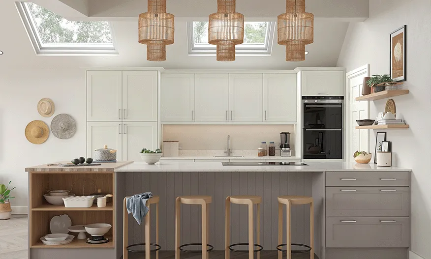 Pale sage kitchen with rattan pendant lights, skylights and breakfast bar stools