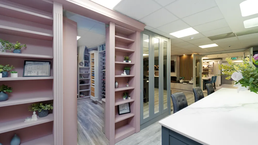 Pink walk in wardrobe display with shelving and shoe storage