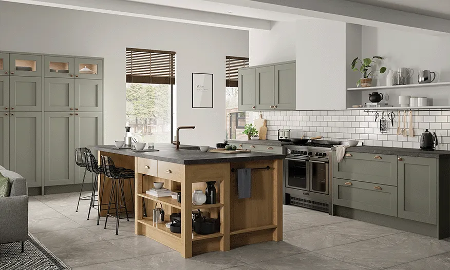 Sage green shaker kitchen with oak island, dark worktop and metro tile splashback