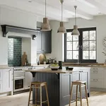 Two tone grey shaker kitchen with green tiled splashback and timber worktops