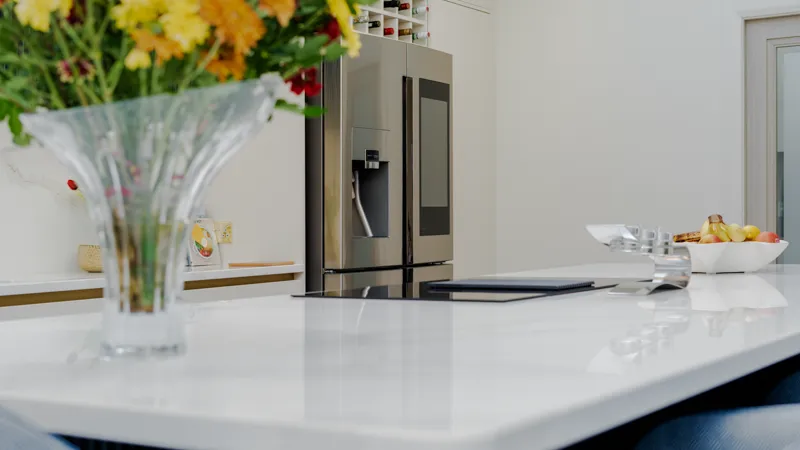 White quartz worktop looking towards a Samsung smart fridge freezer