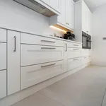 White shaker kitchen drawers with steel handles and cooker hood