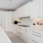 White shaker kitchen with corner larder, induction hob and coffee machine